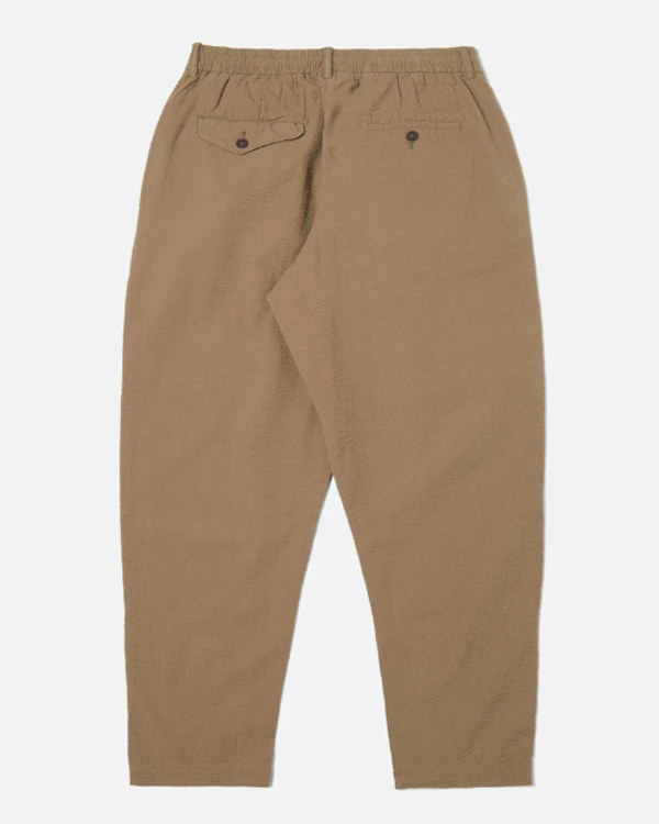 UNIVERSAL WORKS PLEATED TRACK PANT IN OLIVE COTTON SEERSUCKER