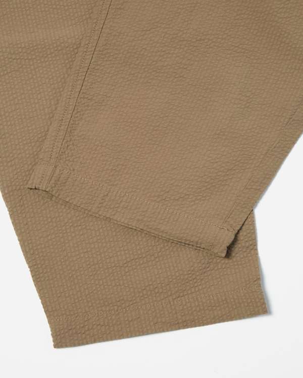 UNIVERSAL WORKS PLEATED TRACK PANT IN OLIVE COTTON SEERSUCKER