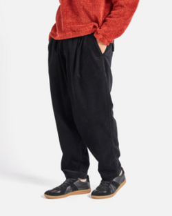 UNIVERSAL WORKS PLEATED TRACK PANT IN BLACK CORD