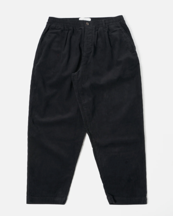 UNIVERSAL WORKS PLEATED TRACK PANT IN BLACK CORD