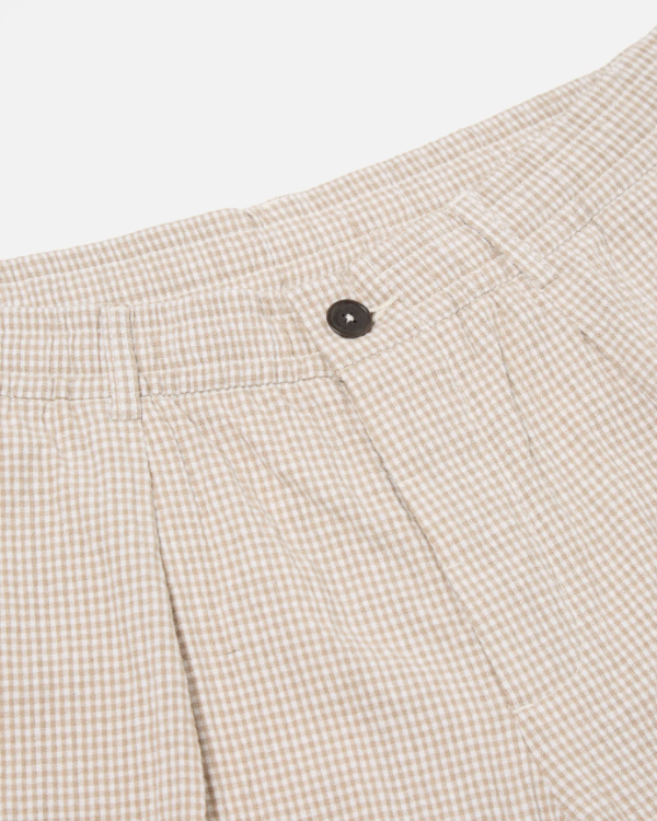 UNIVERSAL WORKS PLEATED TRACK SHORT IN ECRU/SAND OSPINA CHECK COTTON