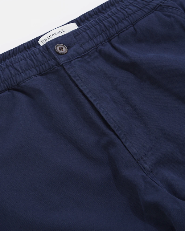 UNIVERSAL WORKS TRACK TROUSER IN NAVY CANVAS